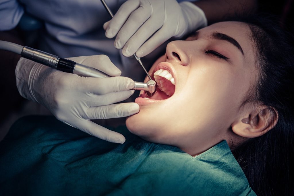 Dentist performing root canal treatment at Aira Dental Clinic in Kokapet for tooth pain relief